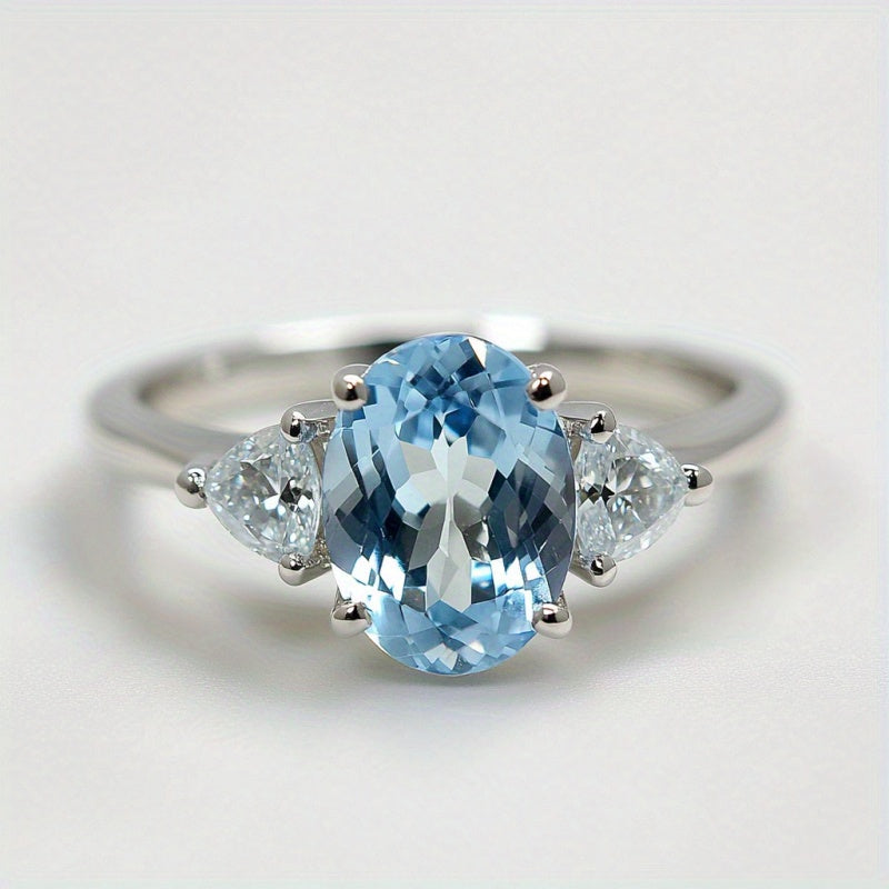 Custom Sky Blue Topaz Three-Stone Oval Ring