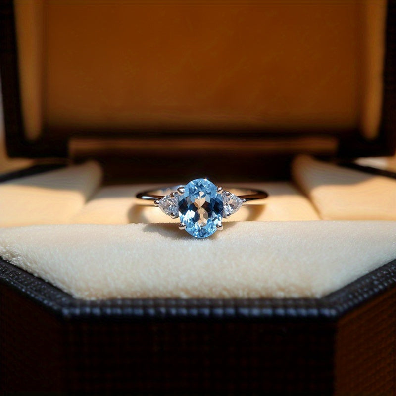 Custom Sky Blue Topaz Three-Stone Oval Ring